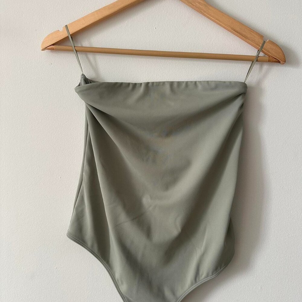 Thong body suit, body contour, thick material.